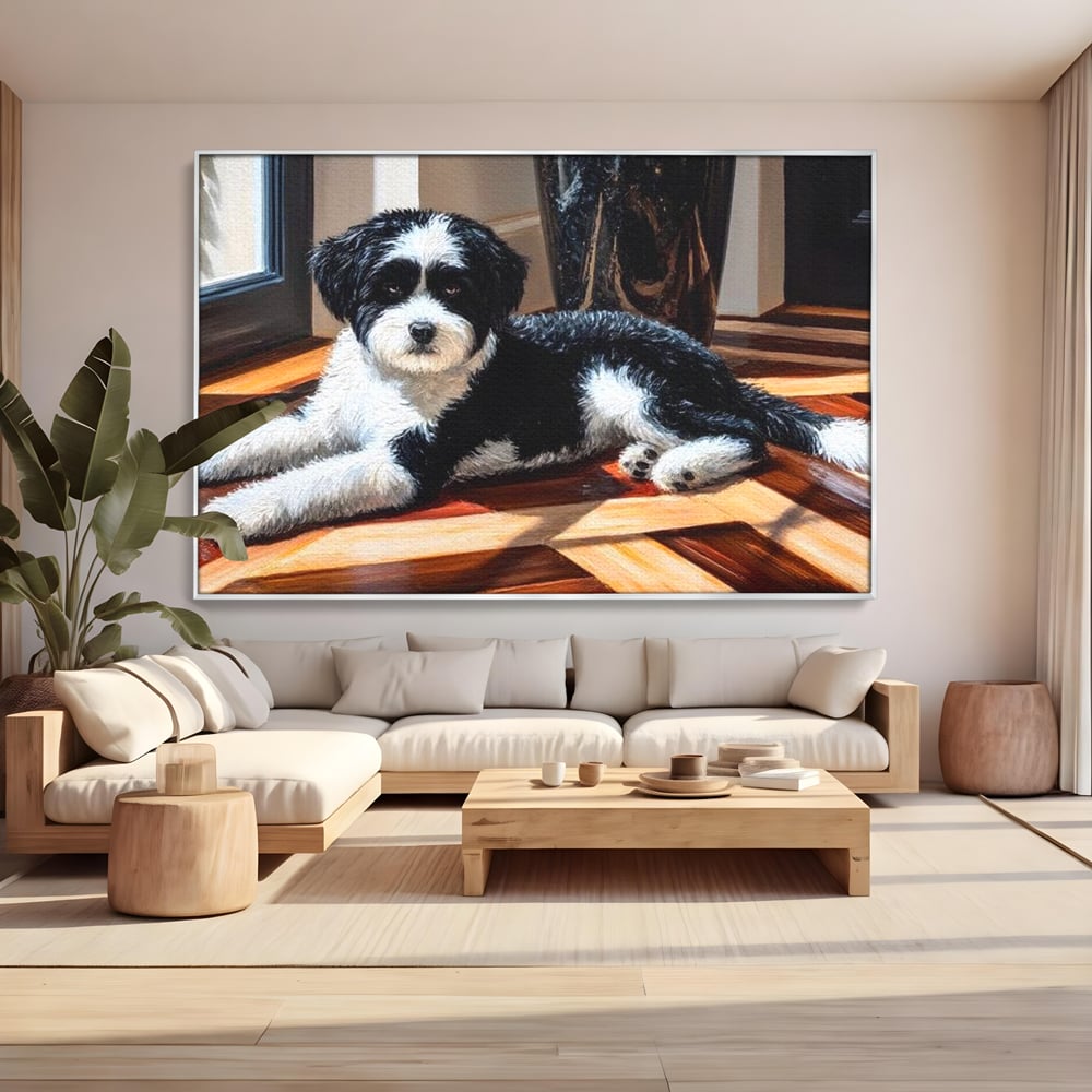 Tablou canvas cu tablou canvas cu catel negru cu alb, in rama de aluminiu argintiu, pe perete intr-un living